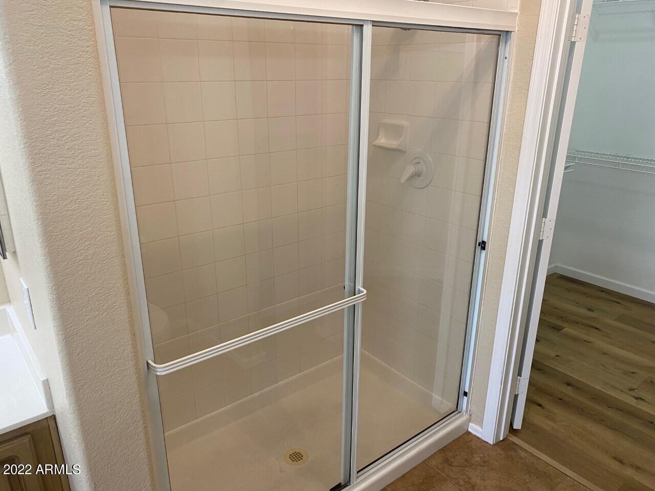 15225 North 100th Street, Unit 2188 Scottsdale, AZ 85260 - Photo 11 of 24 a bathroom with a glass shower door