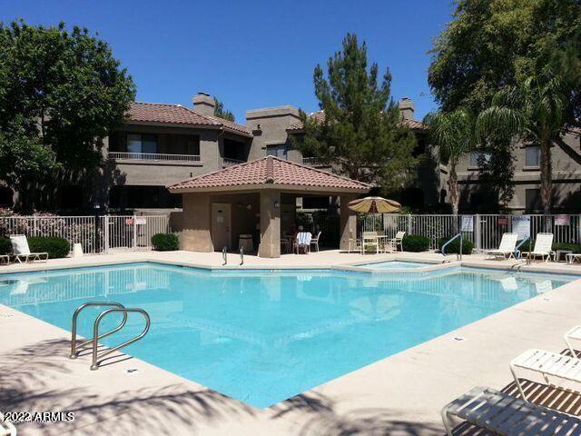 15225 North 100th Street, Unit 2188 Scottsdale, AZ 85260 - Photo 2 of 24 a view of a house with swimming pool and sitting area