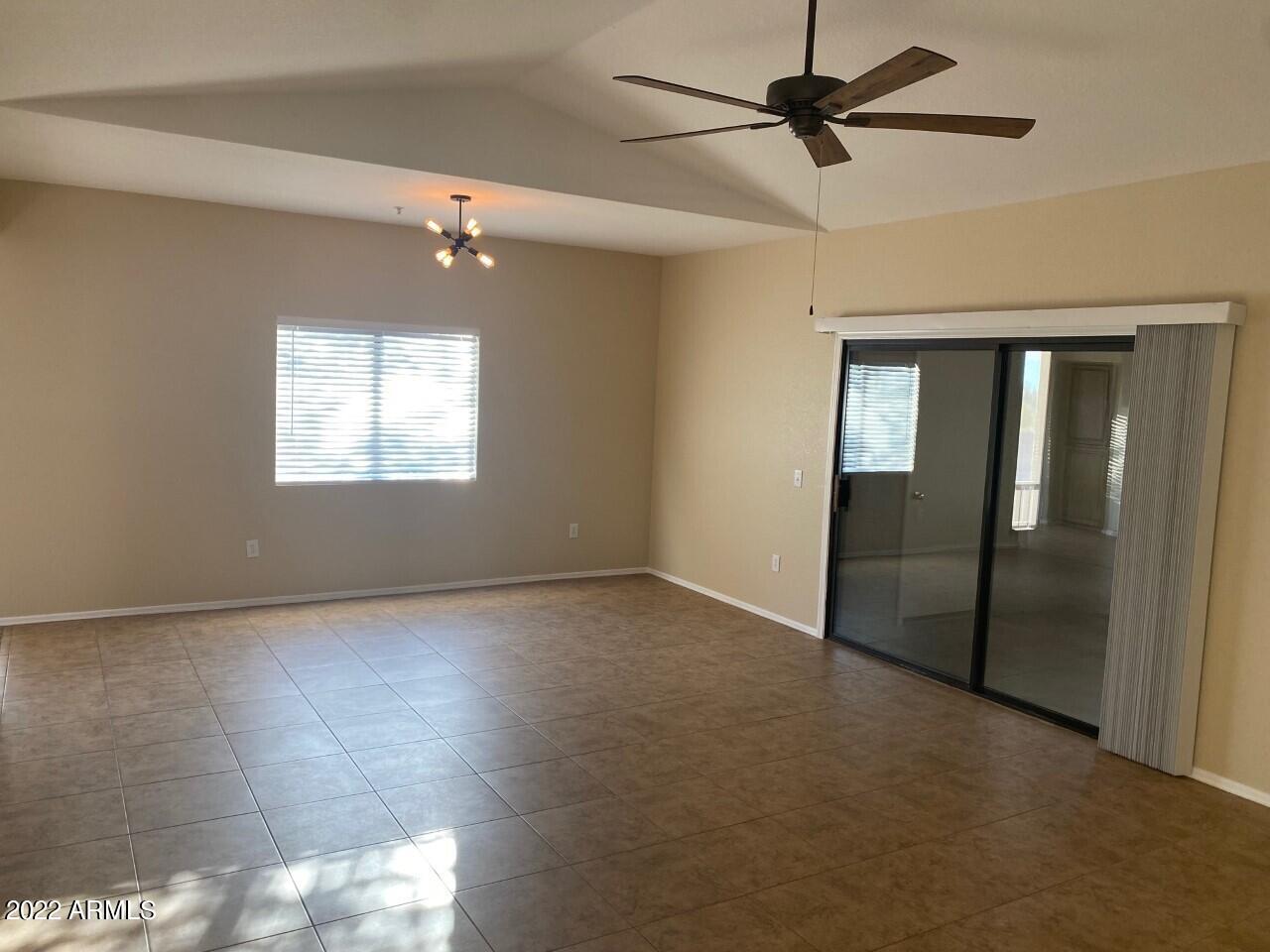 15225 North 100th Street, Unit 2188 Scottsdale, AZ 85260 - Photo 3 of 24 an empty room with windows and fan