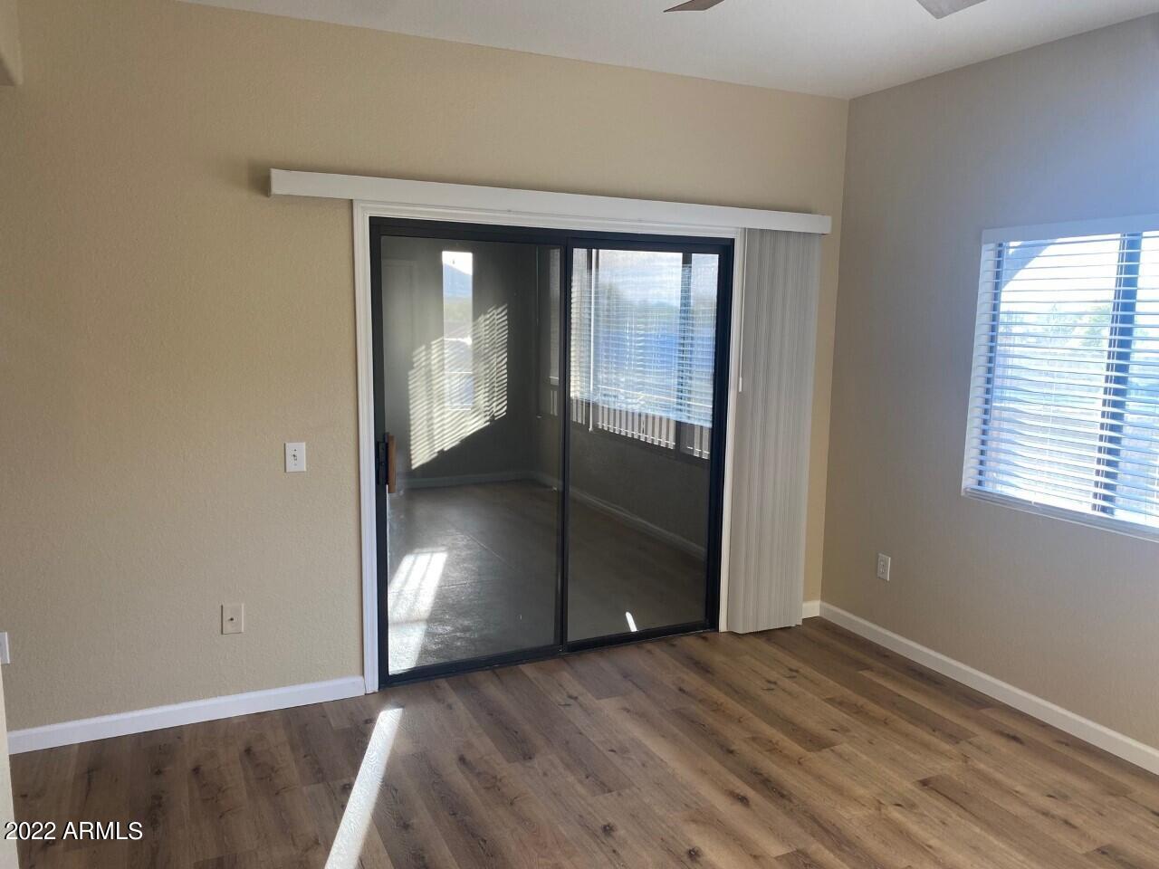 15225 North 100th Street, Unit 2188 Scottsdale, AZ 85260 - Photo 9 of 24 wooden floor in an empty room with a window