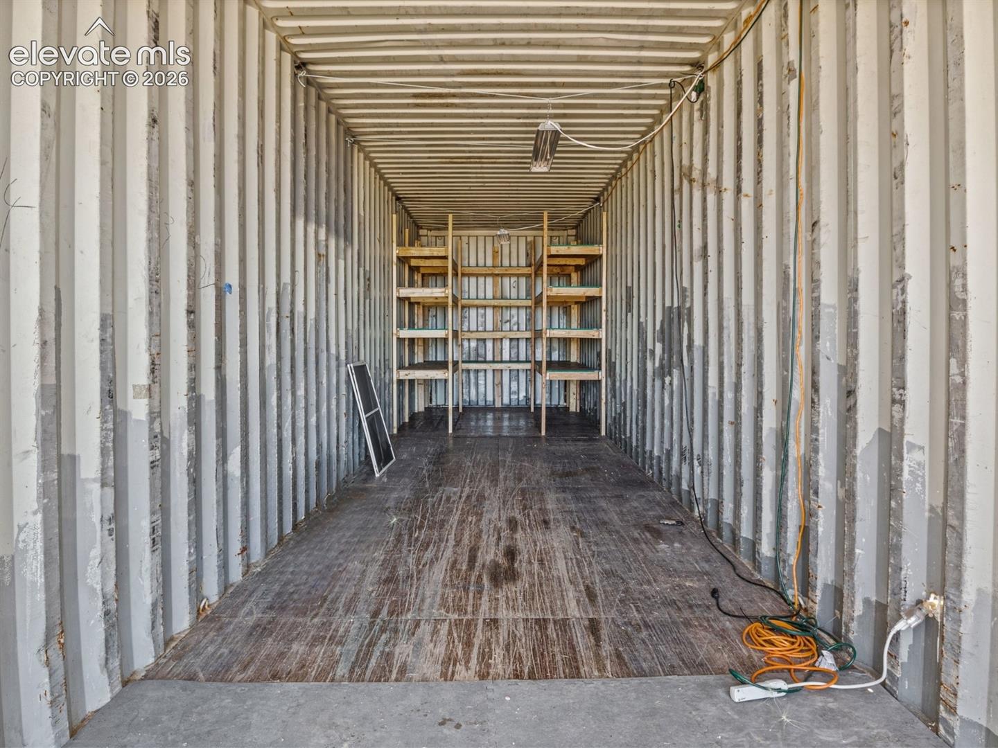6650 Quail Road Fountain, CO 80817 - Photo 36 of 55 Corrugated metal interior with high ceilings and wood-finish flooring