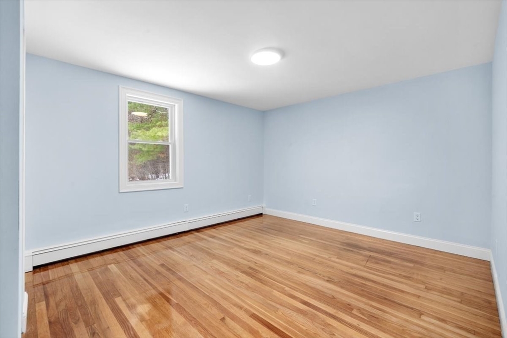 36 Grove Street Hanover, MA 02339 - Photo 16 of 25 an empty room with wooden floor and windows