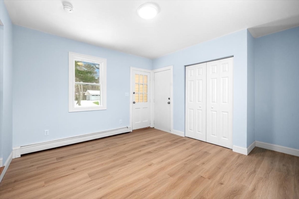 36 Grove Street Hanover, MA 02339 - Photo 2 of 25 an empty room with wooden floor and windows
