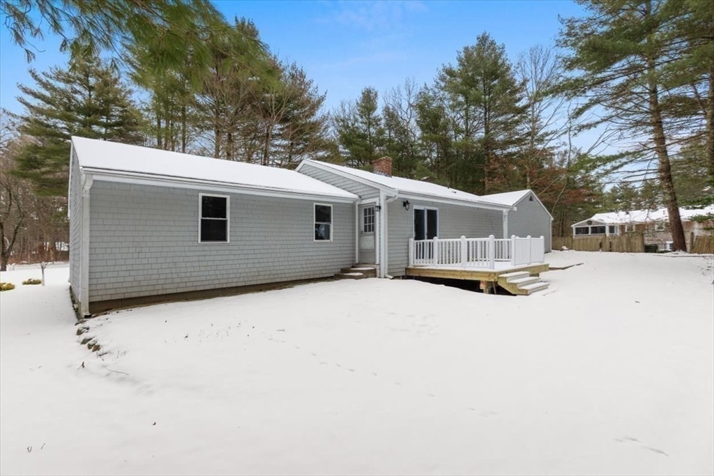 36 Grove Street Hanover, MA 02339 - Photo 22 of 25 a backyard of a house with wooden fence and large trees