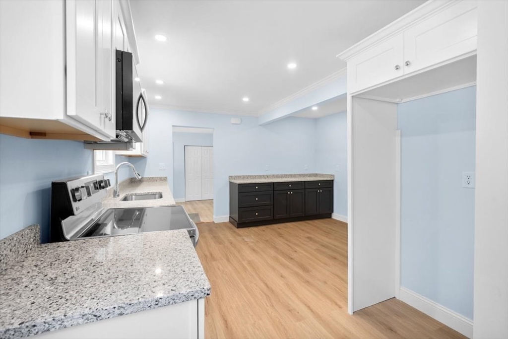 36 Grove Street Hanover, MA 02339 - Photo 6 of 25 a kitchen with stainless steel appliances granite countertop a sink stove and refrigerator
