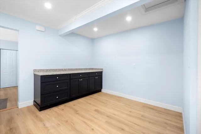 a room with a bed and a dresser