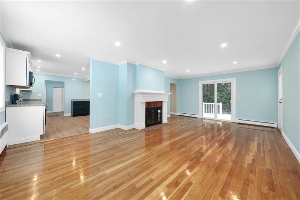36 Grove Street Hanover, MA 02339 - Photo 8 of 25 a view of empty room with wooden floor and fireplace