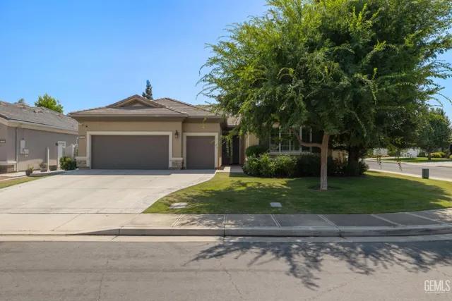 a front view of a house with a yard and a garage