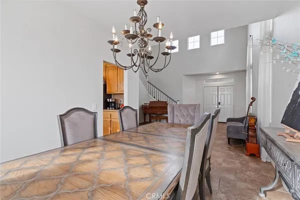 a dining room with furniture and chandelier
