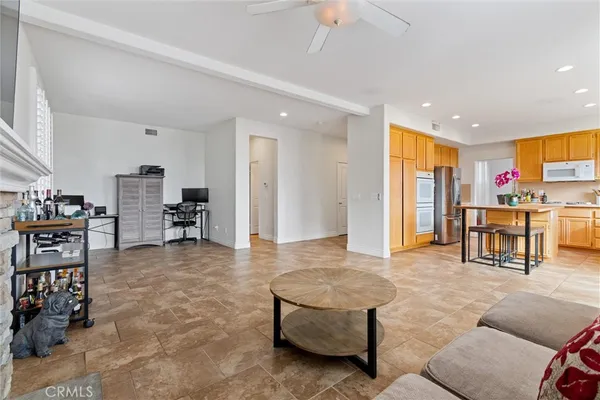 a living room with furniture and kitchen view