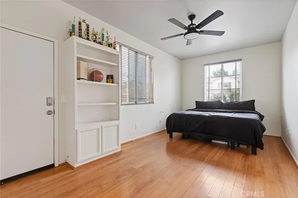 a bedroom with a bed and a ceiling fan