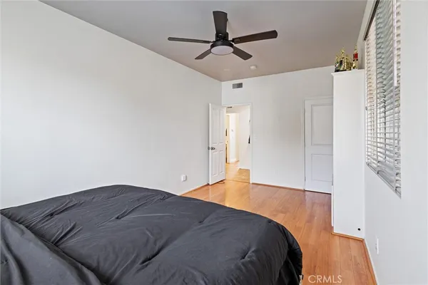 a bedroom with a bed and a ceiling fan