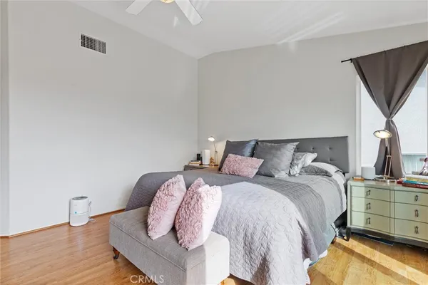 a bedroom with a bed and wooden floor