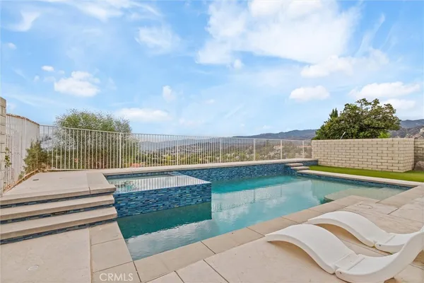 a view of a swimming pool with lounge chair