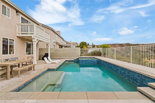 a view of a backyard with sitting area