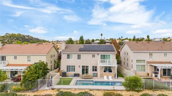 a view of a white house with a yard and plants