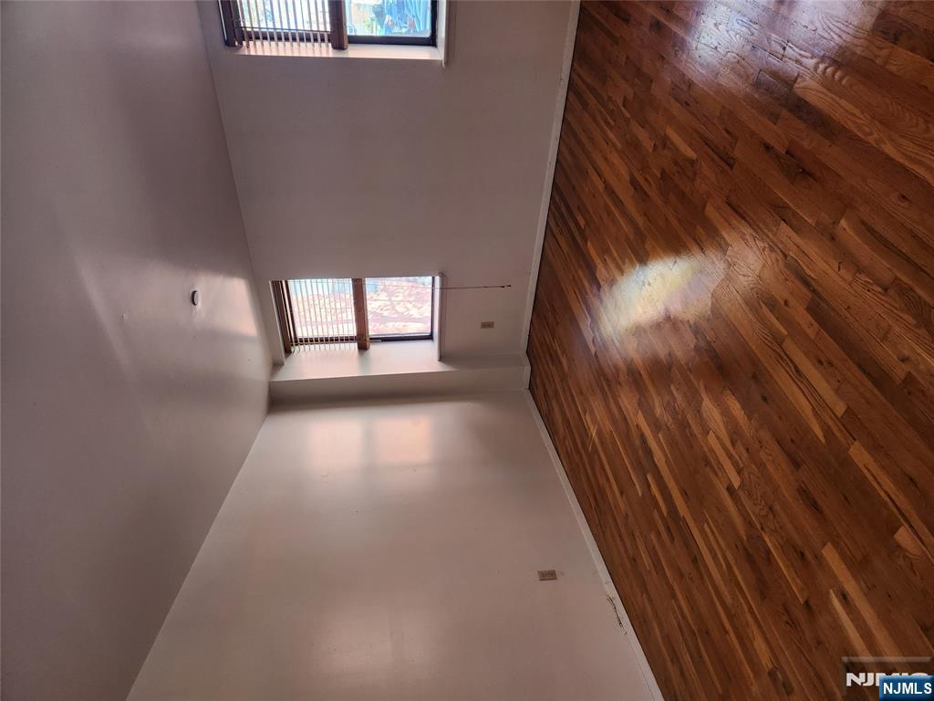 840 River Road, Unit B2 Edgewater, NJ 07020 - Photo 2 of 13 an empty room with wooden floor and windows