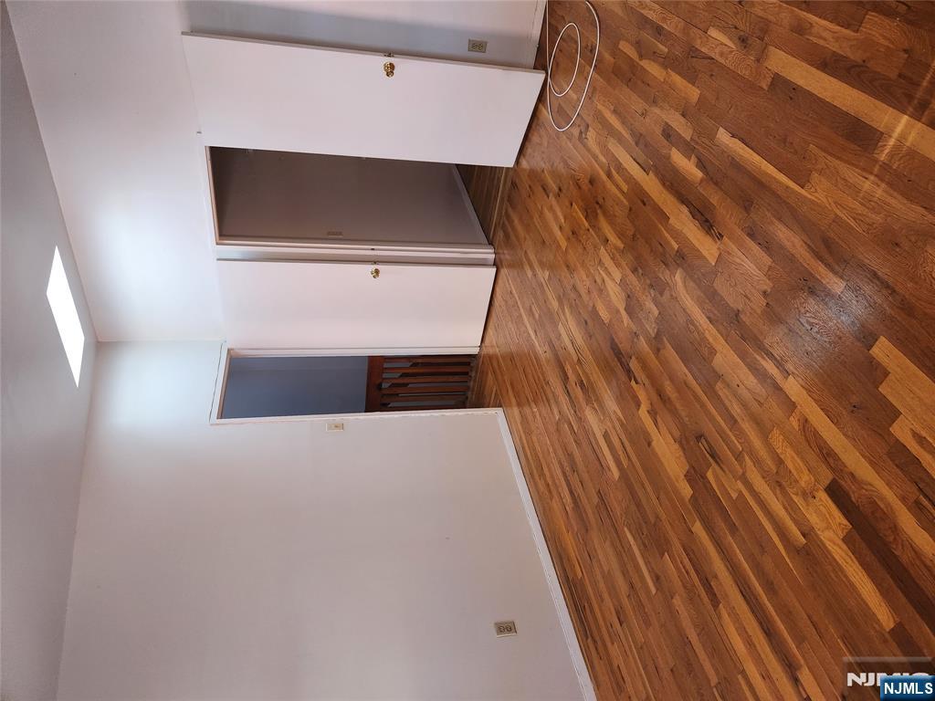 840 River Road, Unit B2 Edgewater, NJ 07020 - Photo 4 of 13 a view of an empty room with closet and wooden floor