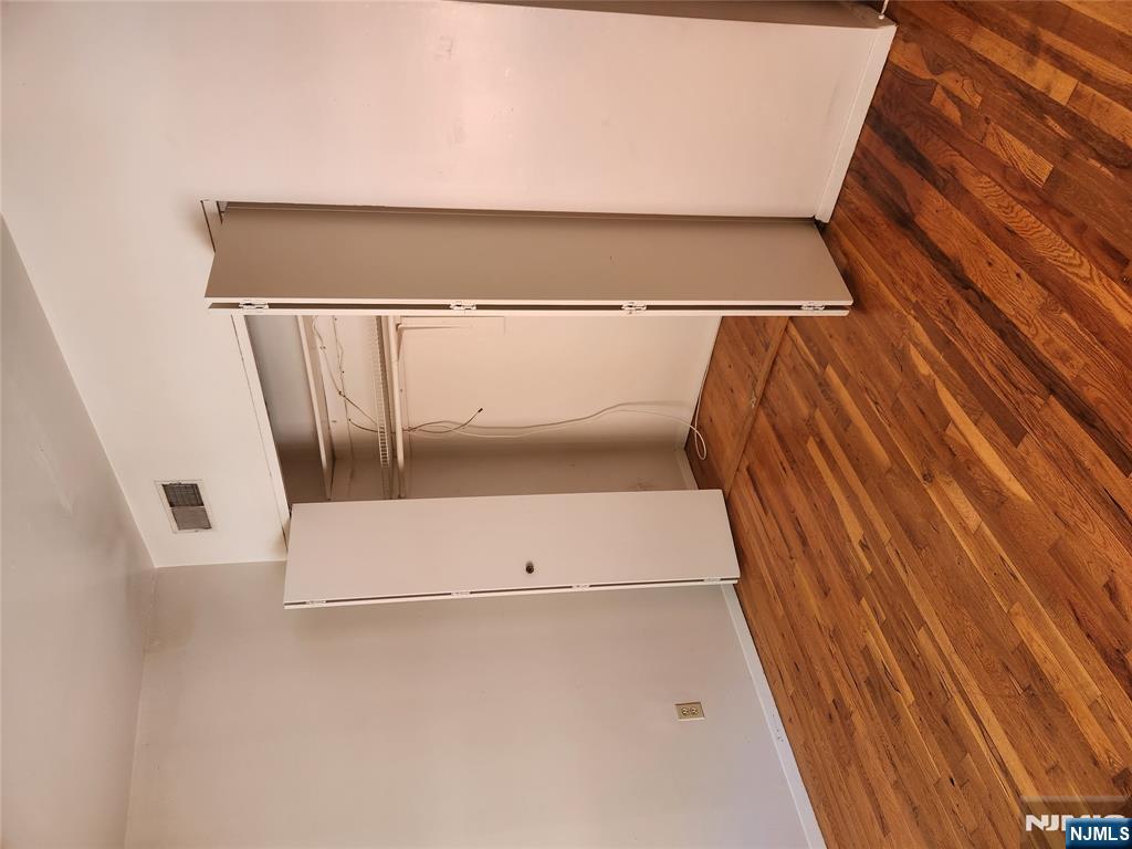 840 River Road, Unit B2 Edgewater, NJ 07020 - Photo 6 of 13 a view of an empty room with wooden floor and a window