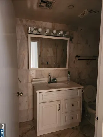 a bathroom with a sink a vanity and a mirror