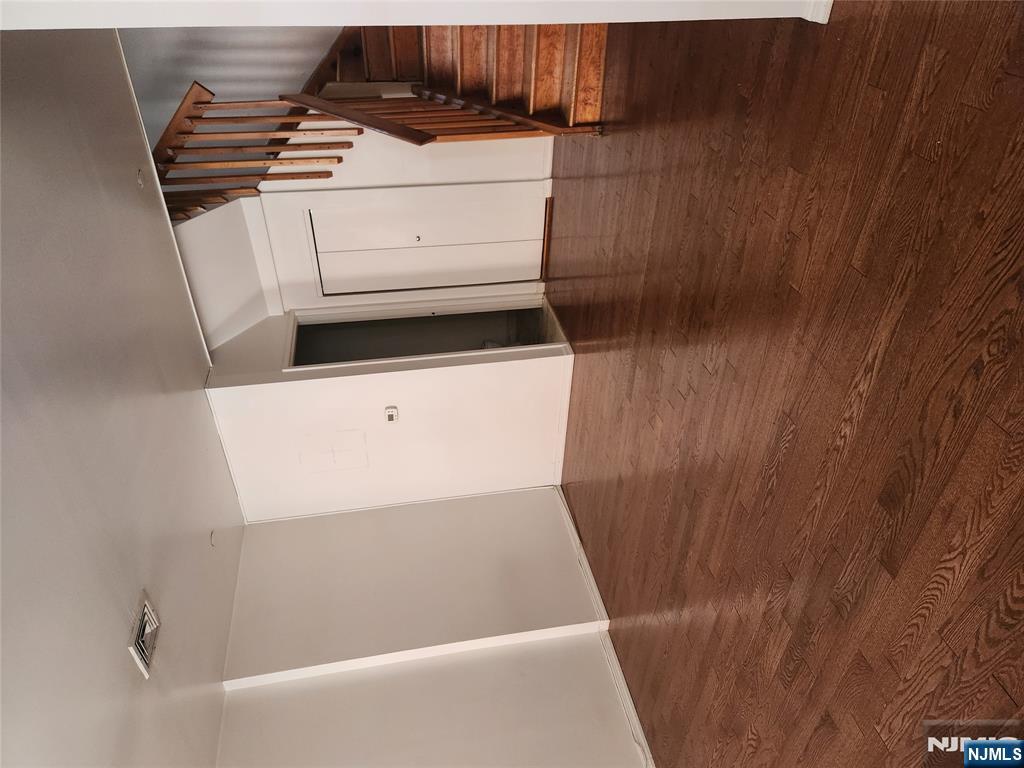 840 River Road, Unit B2 Edgewater, NJ 07020 - Photo 9 of 13 a view of an empty room with wooden floor and stairs