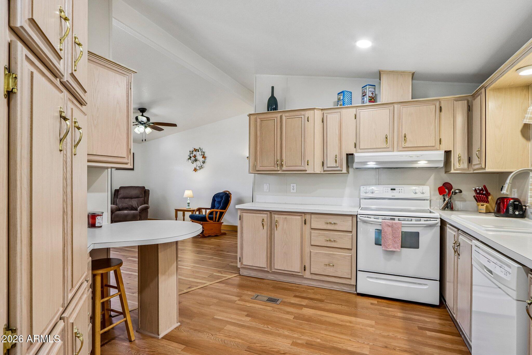 114 South Pinecrest Road Payson, AZ 85541 - Photo 12 of 40 a kitchen with stainless steel appliances granite countertop a stove a sink dishwasher and a refrigerator with wooden floor