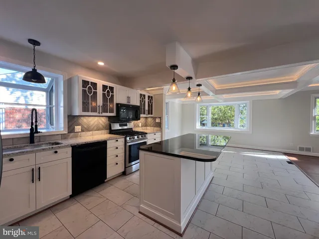 a view of a patio with table and chairs and floor to ceiling window