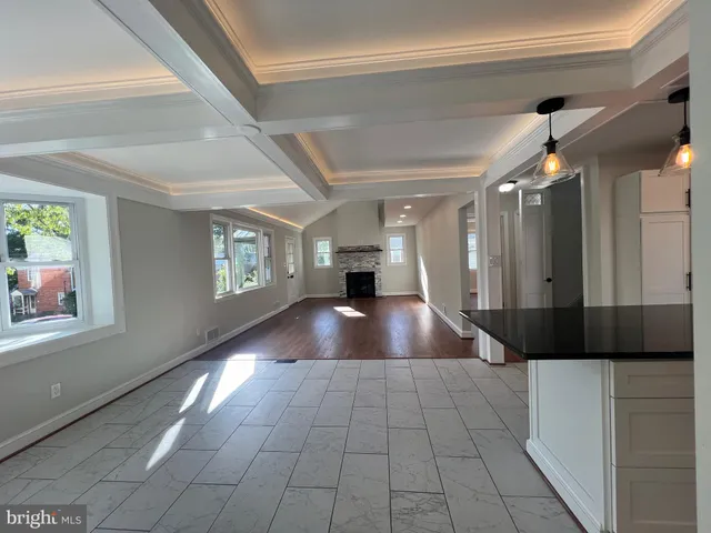 a living room with furniture a flat screen tv and bathroom view