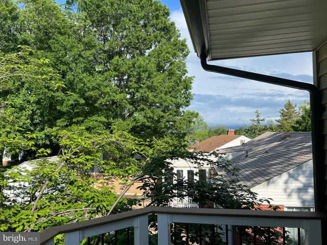 a view of a kitchen with a sink and dishwasher with wooden floor