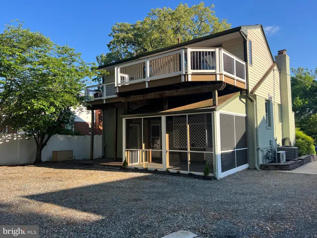 a view of a electric appliances in kitchen and empty room with wooden floor