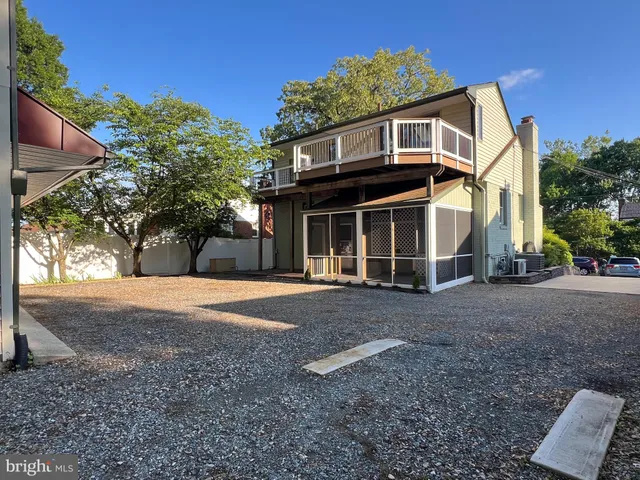 an empty room with wooden floor and fireplace