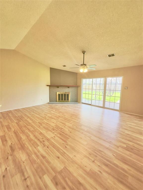 7401 Canoga Circle Fort Worth, TX 76137 - Photo 7 of 17 a view of an empty room with wooden floor and a window