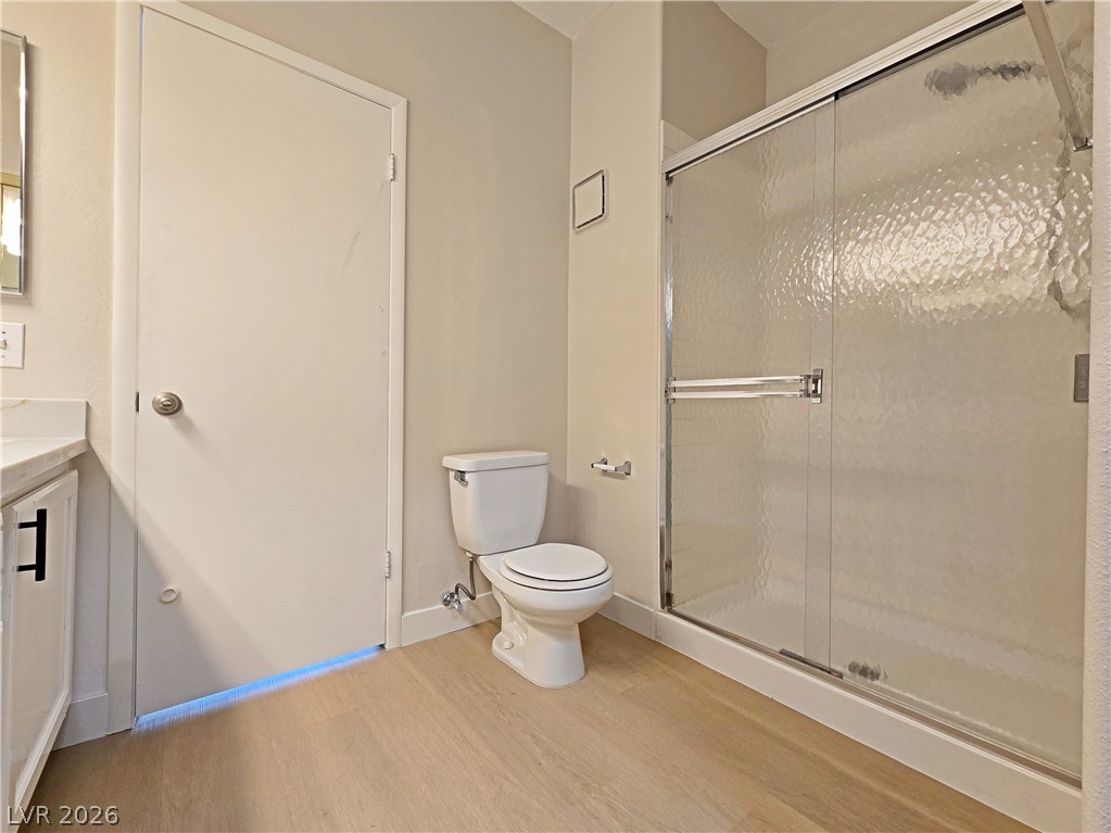 5370 Runningbrook Road Las Vegas, NV 89120 - Photo 22 of 30 Modern bath features a full shower with sliding glass doors and light-hued flooring.