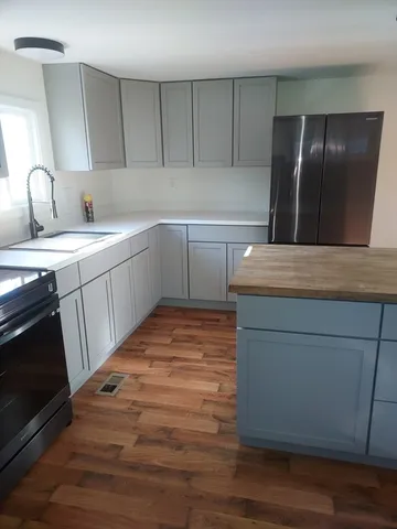 a kitchen with a sink and refrigerator