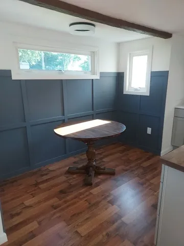 a room with wooden floor and a window