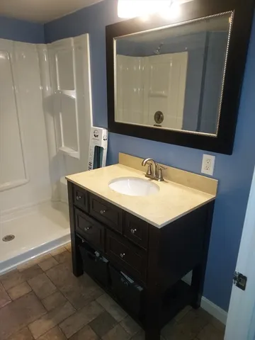 a bathroom with a sink vanity and a mirror