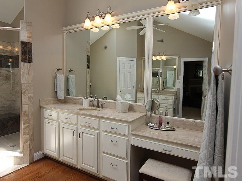 233 Markham Plantation Apex, NC 27523 - Photo 12 of 25 a bathroom with a double vanity sink mirror and shower