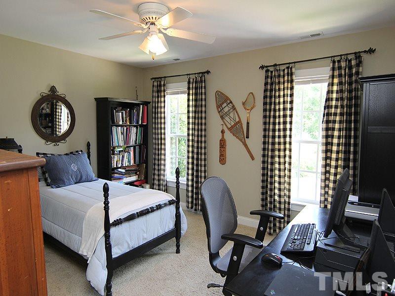 233 Markham Plantation Apex, NC 27523 - Photo 15 of 25 a bedroom with furniture and a window