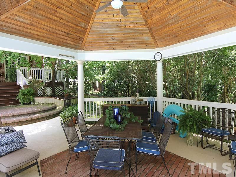 233 Markham Plantation Apex, NC 27523 - Photo 17 of 25 a outdoor living space with furniture and garden view