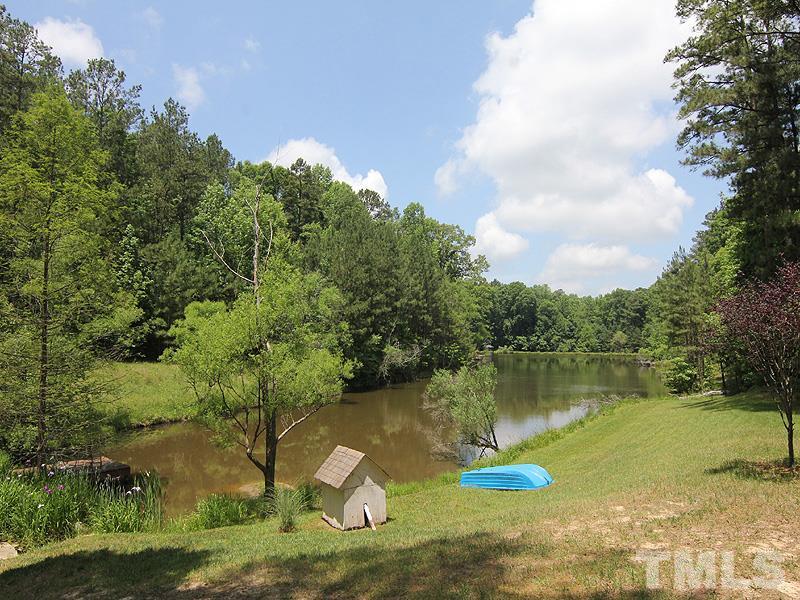 233 Markham Plantation Apex, NC 27523 - Photo 19 of 25 an aerial view of a house with a yard lake and trees in the background