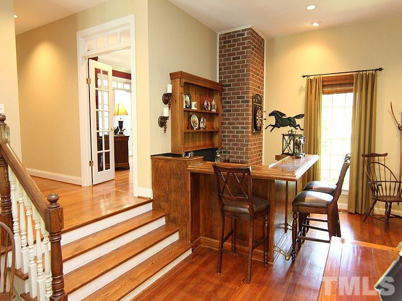 233 Markham Plantation Apex, NC 27523 - Photo 3 of 25 a view of a dining room with furniture window and wooden floor
