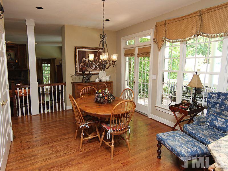 233 Markham Plantation Apex, NC 27523 - Photo 4 of 25 a dining room with furniture window wooden floor