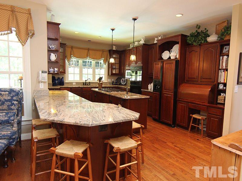 233 Markham Plantation Apex, NC 27523 - Photo 5 of 25 a dining room filled a chandelier and wooden floor