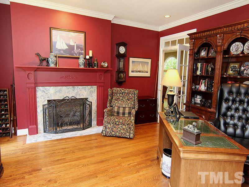 233 Markham Plantation Apex, NC 27523 - Photo 7 of 25 a living room with furniture and a fireplace