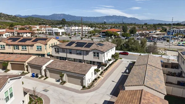 an aerial view of a house with a mountain