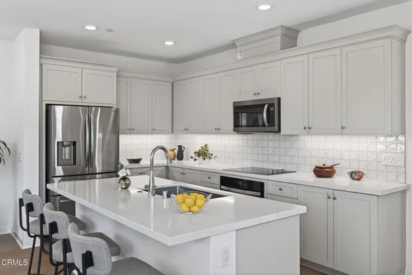 a kitchen with a sink a stove and refrigerator