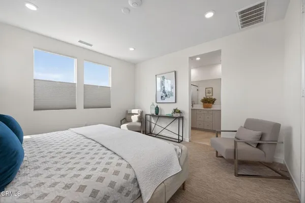 a bedroom with a bed and a couch