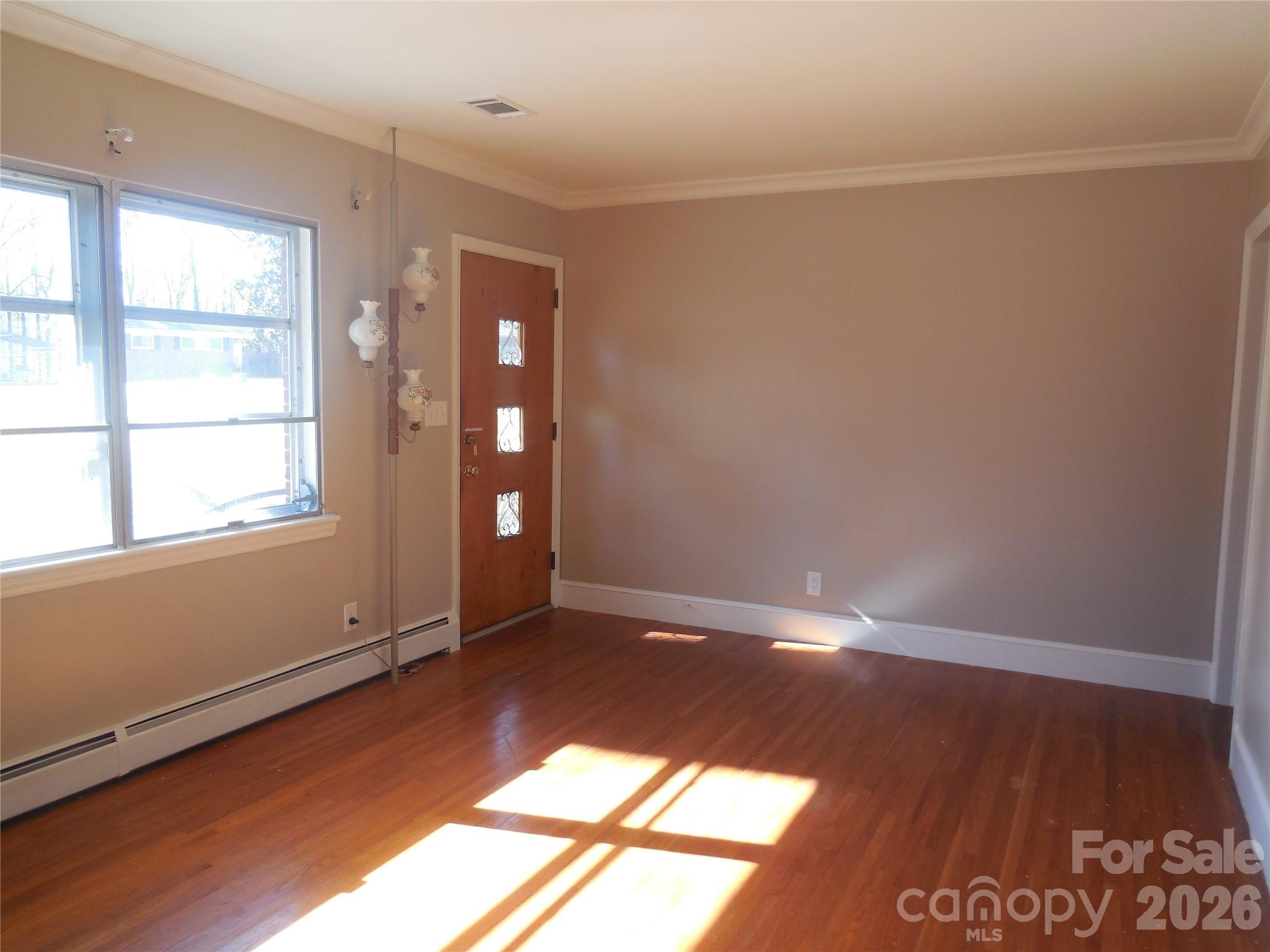 781 Denning Place Charlotte, NC 28227 - Photo 3 of 10 an empty room with wooden floor and windows