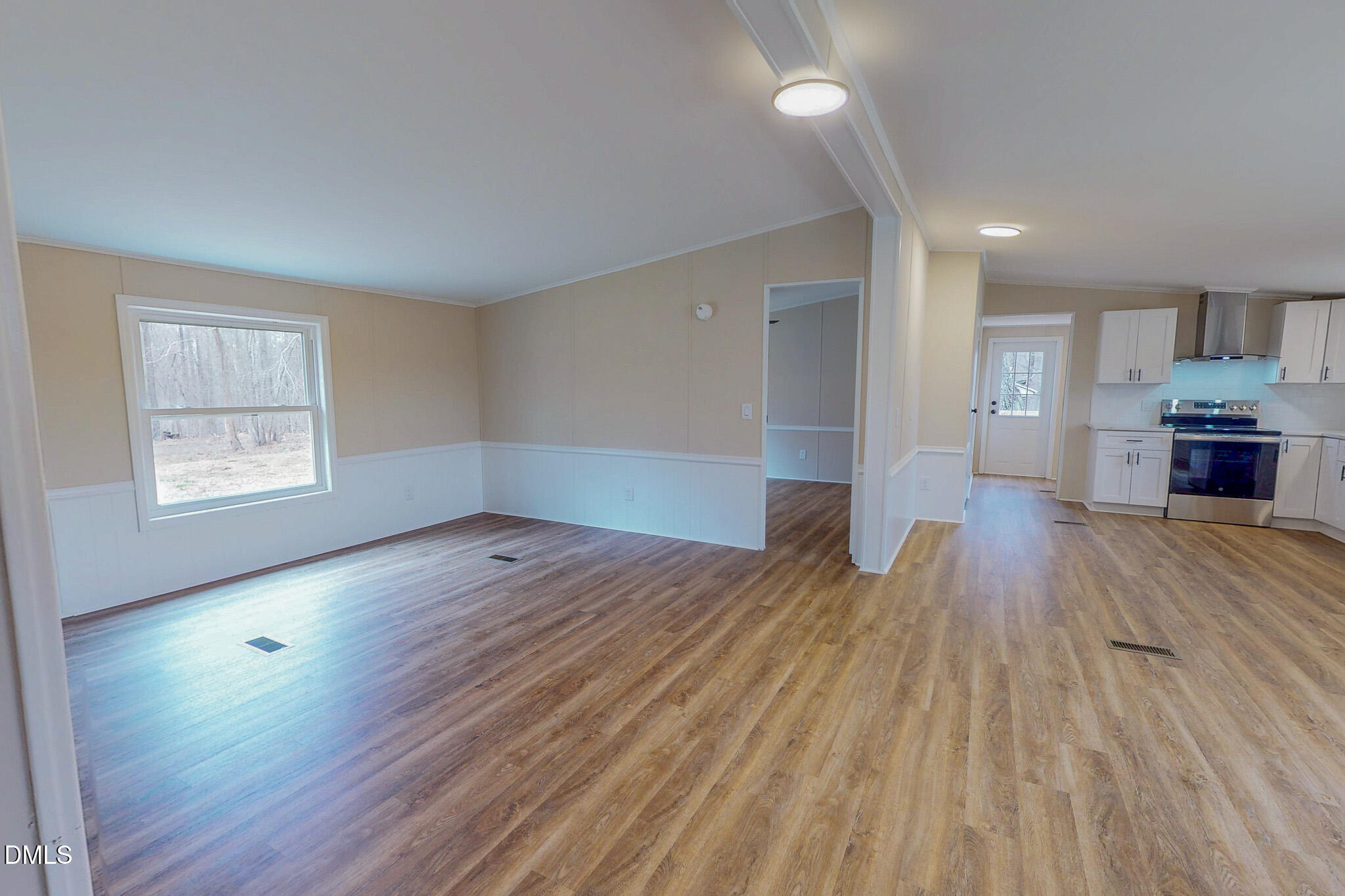 67 Halifax Road Roxboro, NC 27574 - Photo 10 of 48 an empty room with wooden floor and windows