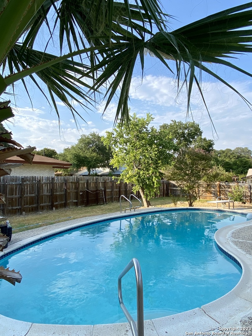 a view of a swimming pool with an outdoor space and seating area